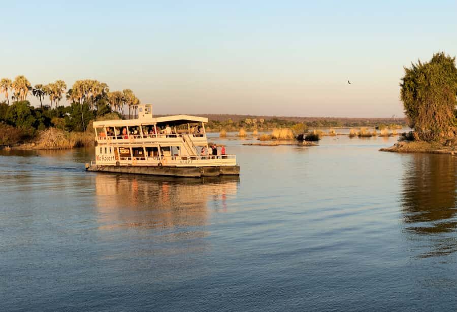 Victoria Falls Scenic Guided Tour with Sunset Boat Cruise - Entering Victoria Falls: 16 viewpoints and the Big Tree photo moment