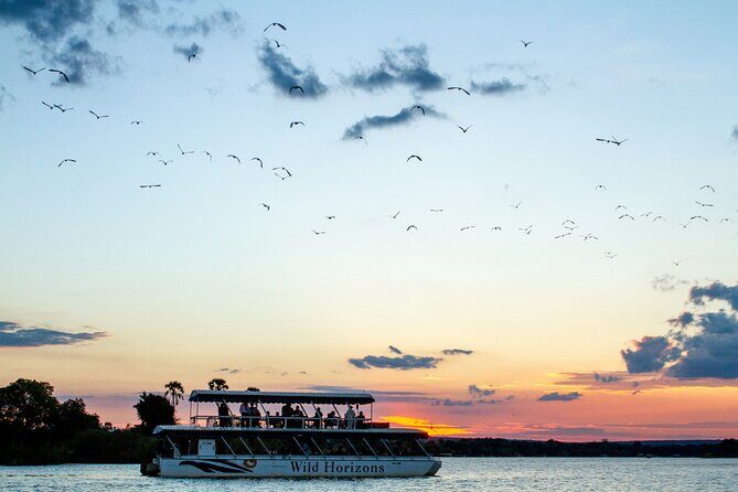 Zambezi River Sunset Cruise, from Victoria Falls, Zimbabwe - Standard deck vs upper-deck upgrade: same sunset, different vantage